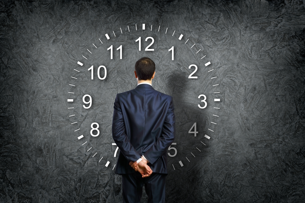 Businessman standing and making his choice between times-3